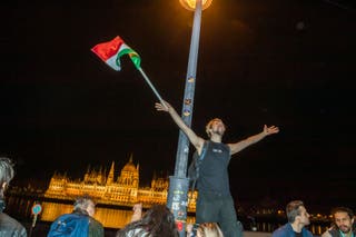 People celebrate in the streets after Hungarian Prime Minister Viktor Orban conceded defeat to Peter Magyar, leader of the pro-European conservative TISZA party, in Budapest, on April 12, 2026